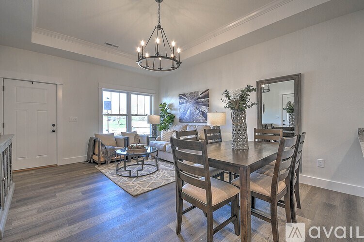A dining room with a wooden table and chairs.