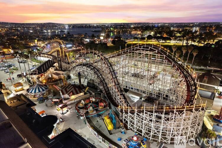 A roller coaster is under construction in a park.