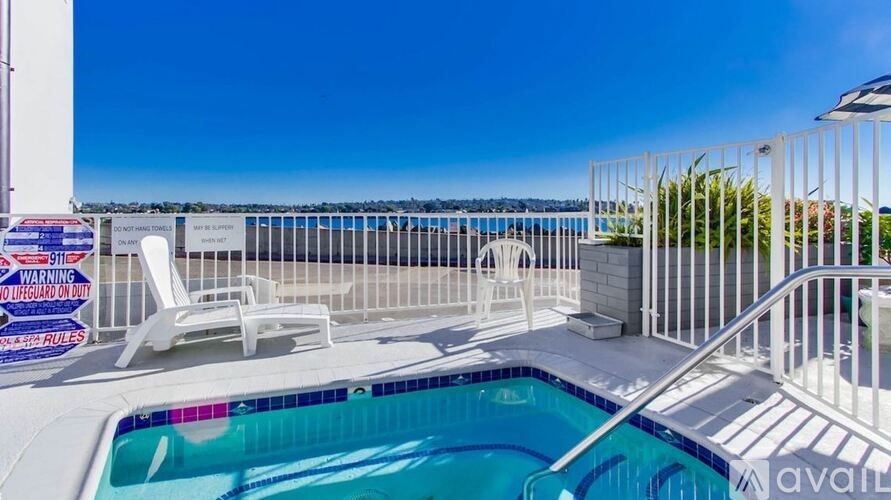 A pool with a chair and a sign that says "WARNING DO NOT ENTER ONLY".
