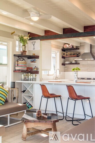 A kitchen with a bar area and two chairs.