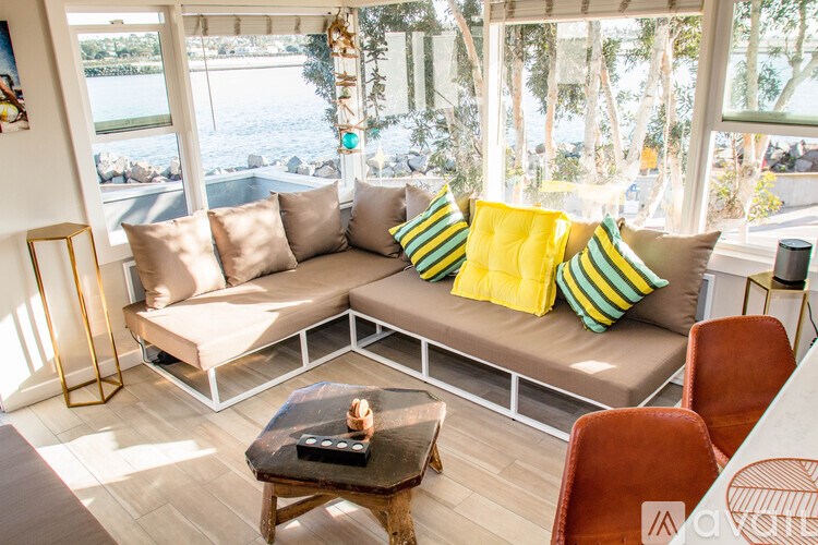 A living room with a couch, chairs, and a coffee table.