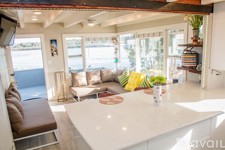 A living room with a white countertop and a brown couch.