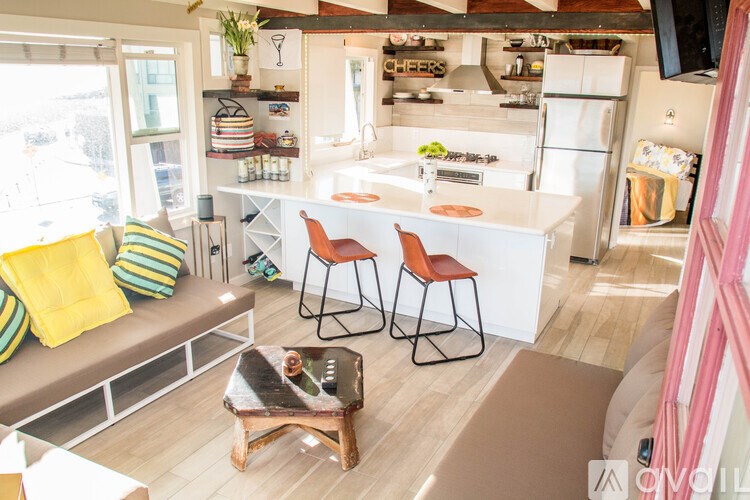 A kitchen with a white fridge and a white counter top.