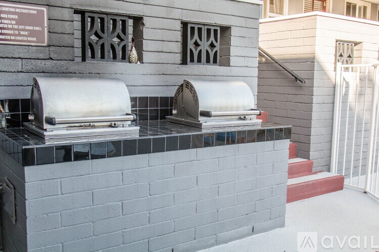 Two toasters are on a counter with a sign above them.