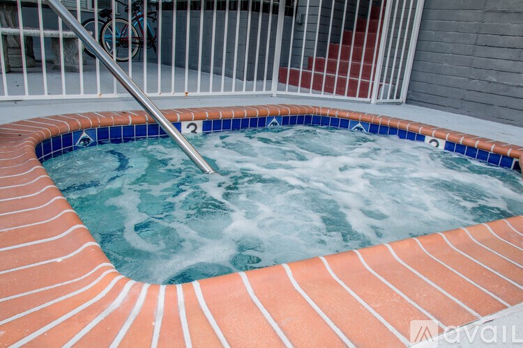 A hot tub with a metal handle is in the foreground.