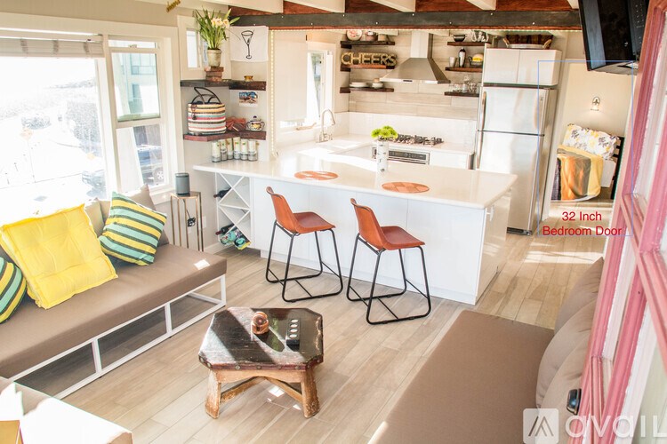A kitchen with a white counter and a white fridge.