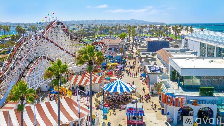 A roller coaster ride in the middle of a bustling amusement park.