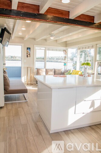 A living room with a white counter and a brown couch.