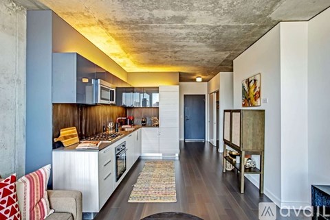 A kitchen with a blue wall and a white counter.