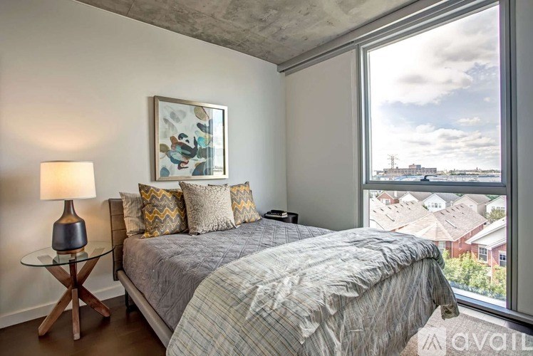 A bedroom with a large bed and a view of the city.