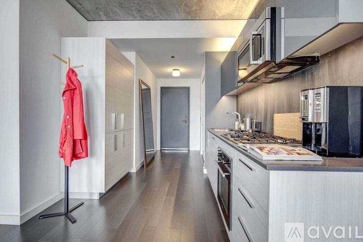 A kitchen with a red jacket hanging on a hook.