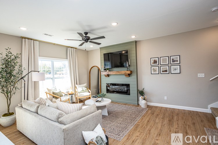 A living room with a white couch and a ceiling fan.