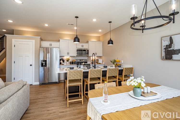 A modern kitchen with a dining table set for four.