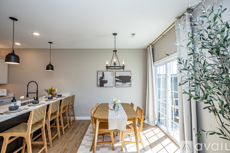 A dining room with a table set for four.