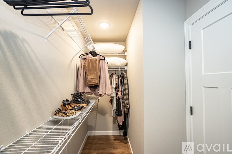 A hallway with a coat hanging on the rack.