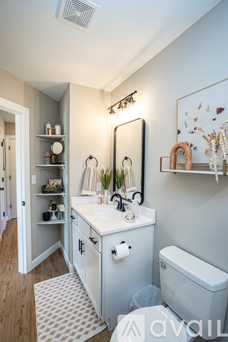 A bathroom with a white vanity and a toilet.