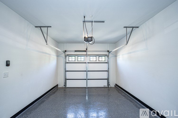 A spacious garage with a lift in the middle.