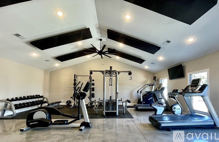 A spacious home gym with a variety of exercise equipment.