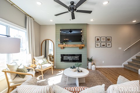 A living room with a fireplace and a television above it.