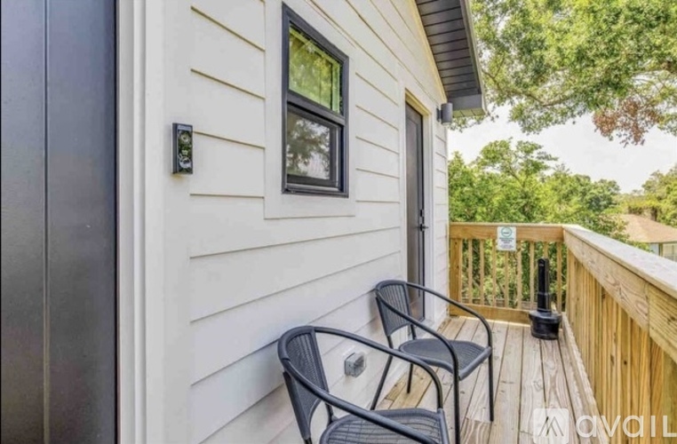 A small balcony with a table and two chairs.