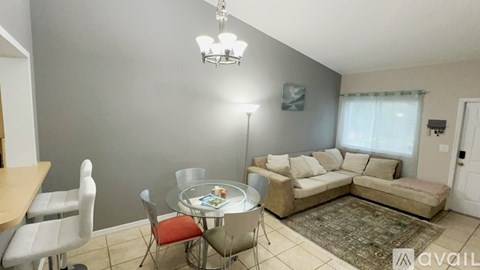 A living room with a dining table and chairs.