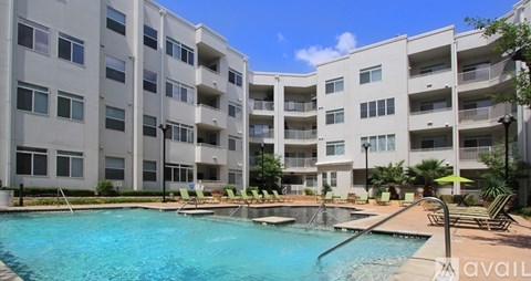 A large swimming pool in front of apartment buildings.