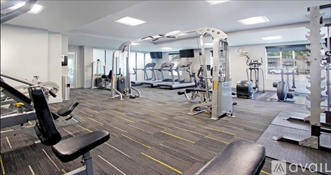 A gym with a variety of equipment including a leg press machine.