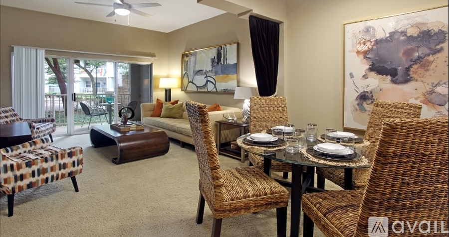 A living room with a dining table set up with chairs around it.