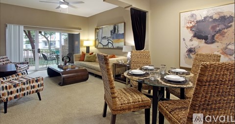 A living room with a dining table set up with chairs around it.