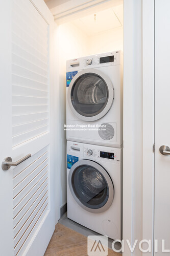 A white washer and dryer in a small room.