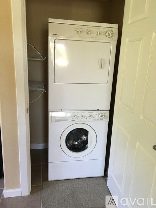 A white washing machine and dryer in a small laundry room.