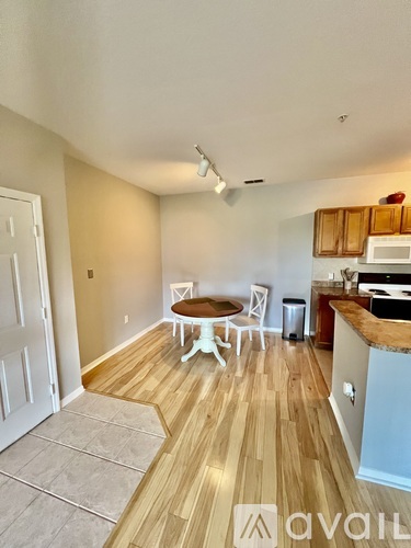 A kitchen with a table and chairs in the middle of the room.