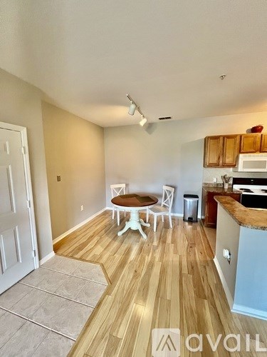 A kitchen with a table and chairs in the middle of the room.