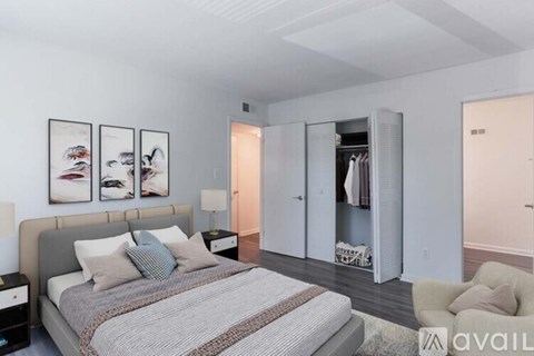 A bedroom with a large bed and a couch.