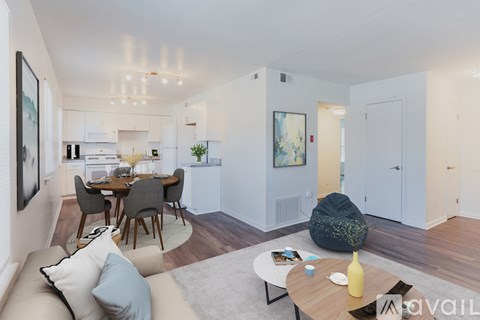 A modern living room with a dining table and chairs.