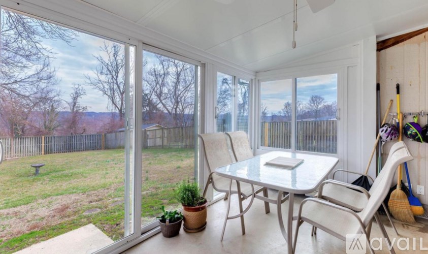 A sunny patio with a table and chairs.