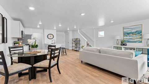 A modern living room with a dining table and chairs.