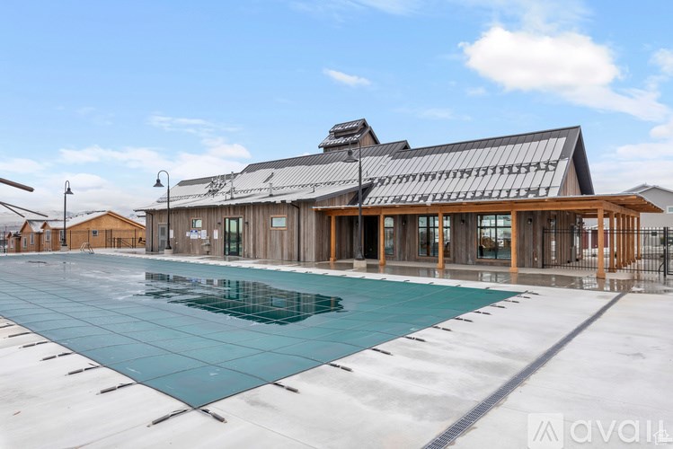 A large building with a pool in front of it.