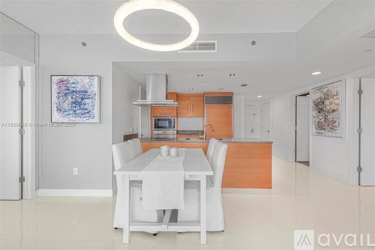 A modern kitchen with a dining table and chairs.