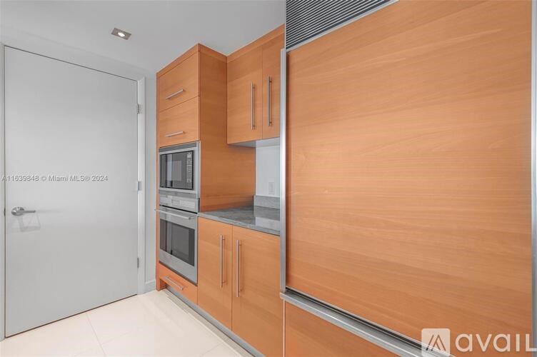 A kitchen with wooden cabinets and a stainless steel countertop.