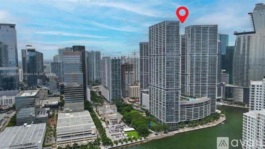 A red location marker is placed on a tall building in a cityscape.