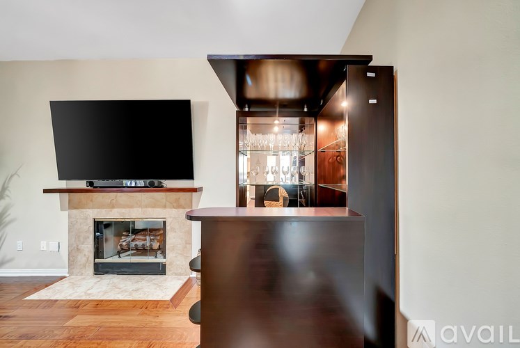 A modern living room with a fireplace and a television.