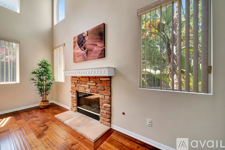 A living room with a fireplace and a painting on the wall.
