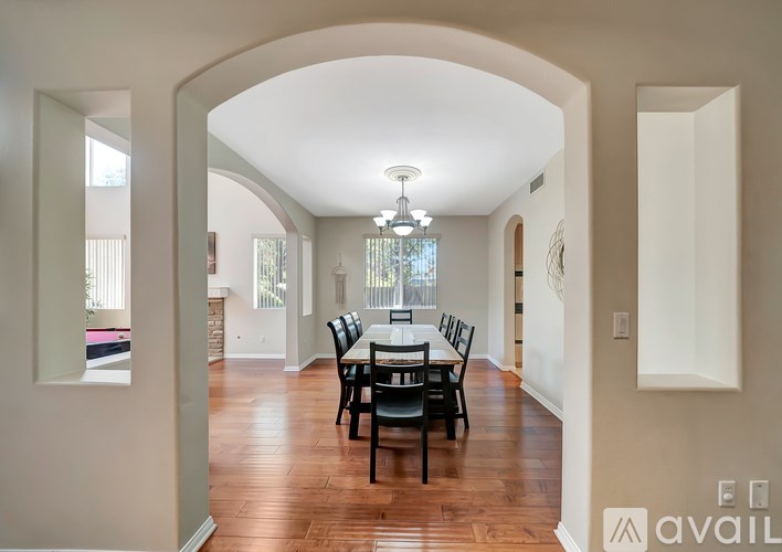 A dining room with a table set for four.