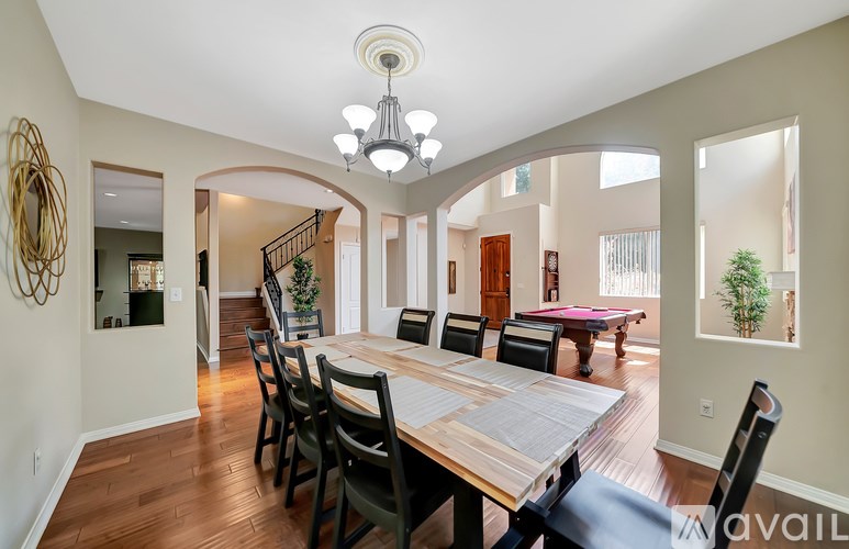 A dining room with a wooden table and chairs.