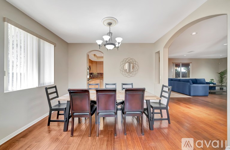 A dining room with a table set for six.
