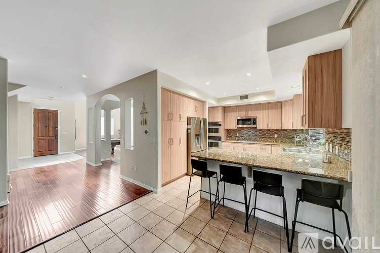 A kitchen with a bar area and a dining area.