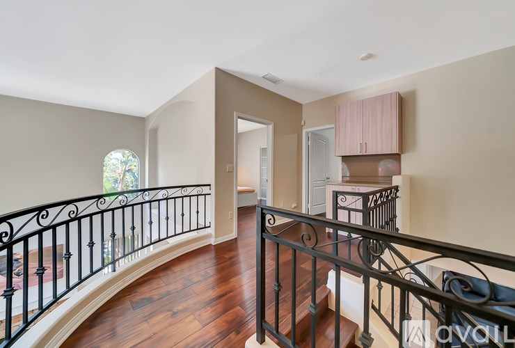 A living room with a staircase and a window.