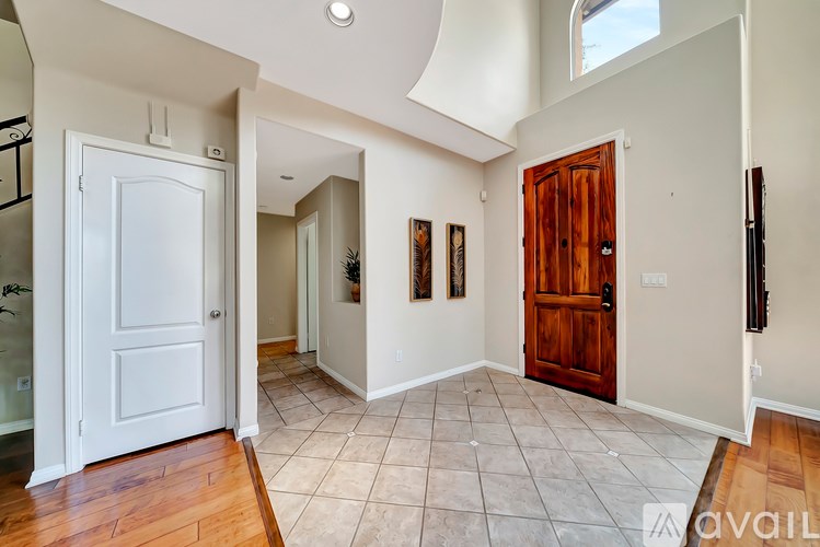 A hallway with a white door and a brown door.