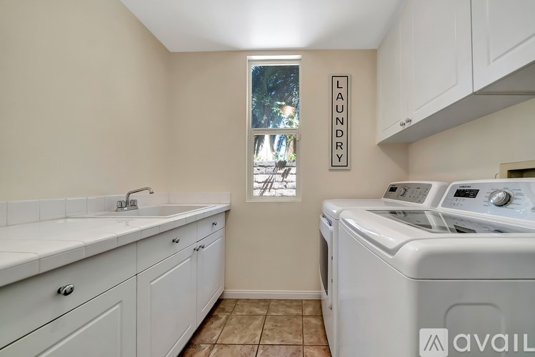 A laundry room with a washer and dryer and a window.